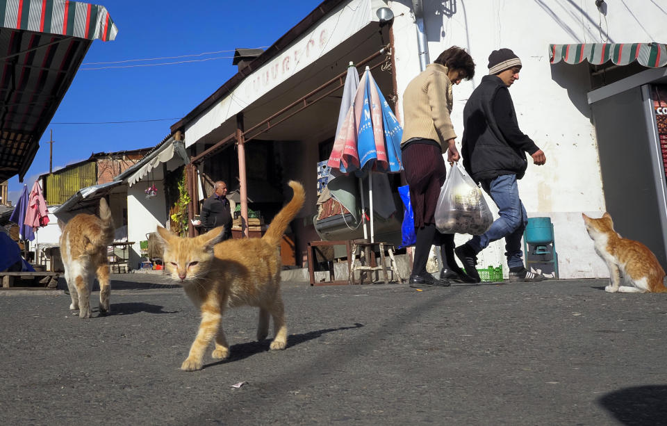 People walk in a market during a military conflict in Stepanakert, the separatist region of Nagorno-Karabakh, Saturday, Oct. 10, 2020. Armenia and Azerbaijan have agreed to a Russia-brokered cease-fire in Nagorno-Karabakh after two weeks of heavy fighting that marked the worst outbreak of hostilities in the separatist region in more than a quarter-century. (AP Photo)