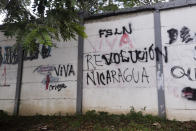 A wall that is defaced with graffiti with one message that once read in Spanish: "Resist Nicaragua", was overpainted by another that now reads "Long live the Nicaraguan revolution", in Managua, Nicaragua, Thursday, June 17, 2021. In recent weeks, Nicaragua President Daniel Ortega's government has rounded up 13 opposition leaders, including four presidential challengers for the Nov. 7 elections. They face allegations ranging from money laundering to crimes against the state. (AP Photo/Miguel Andres)