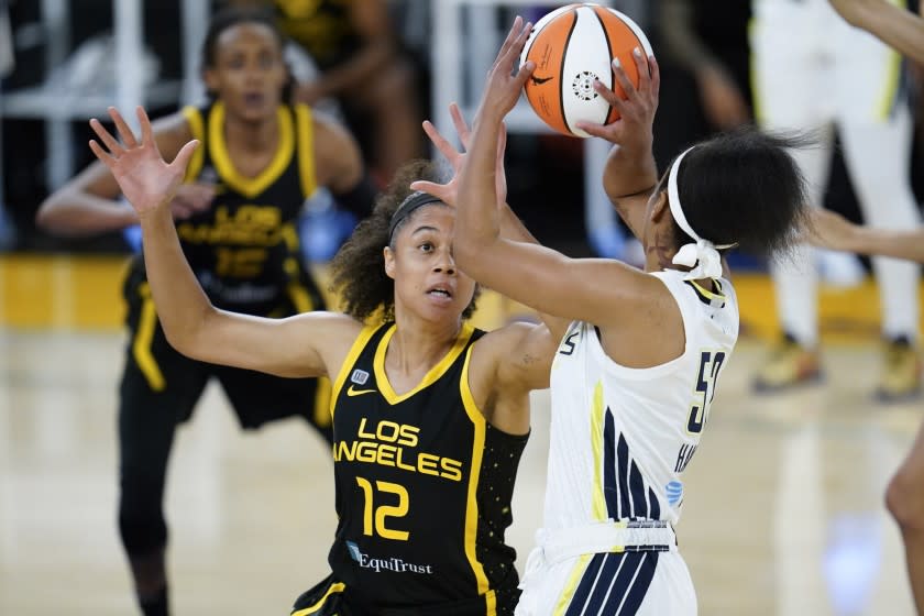 Los Angeles Sparks forward Nia Coffey (12) defends against Dallas Wings guard Tyasha Harris (52) during the first quarter of a WBNA basketball game Friday, May 14, 2021, in Los Angeles. (AP Photo/Ashley Landis)