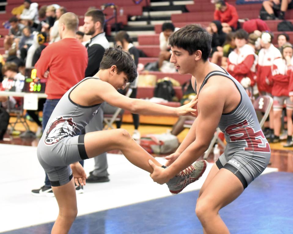 South Effingham wrestlers Emilio Santana (106 pounds), left, and his brother Enrique Santana (160) warm up just before intermission at matches on Nov. 24. 