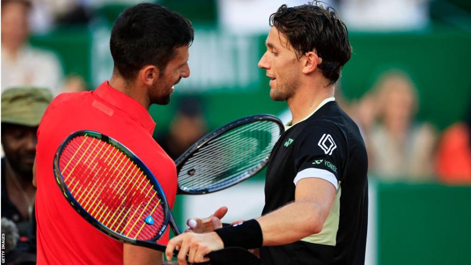 Casper Ruud shakes hands with Novak Djokovic