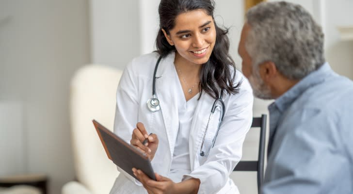 A medical professional explaining Medicare premiums to a patient.