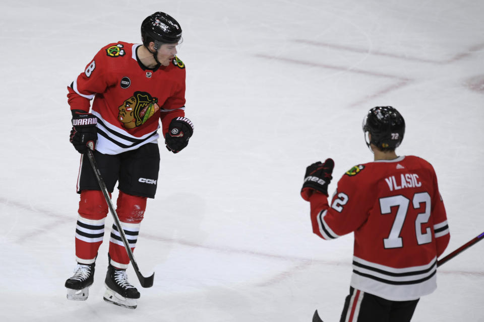 Chicago Blackhawks' Ryan Donato (8) celebrates with Alex Vlasic (72) after scoring a goal against the Anaheim Ducks during the first period of an NHL hockey game Tuesday, March 12, 2024, in Chicago. (AP Photo/Paul Beaty)