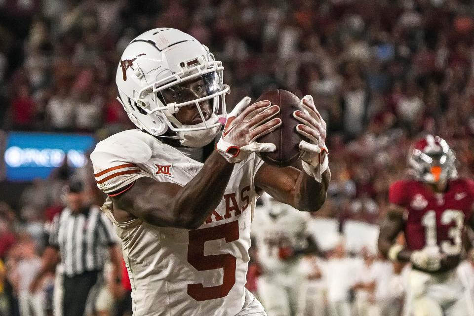 Texas wide receiver Adonai Mitchell catches one of his two touchdowns in Saturday night's 34-24 win over Alabama. The Georgia transfer has three touchdown grabs in his firs two games as a Longhorn.