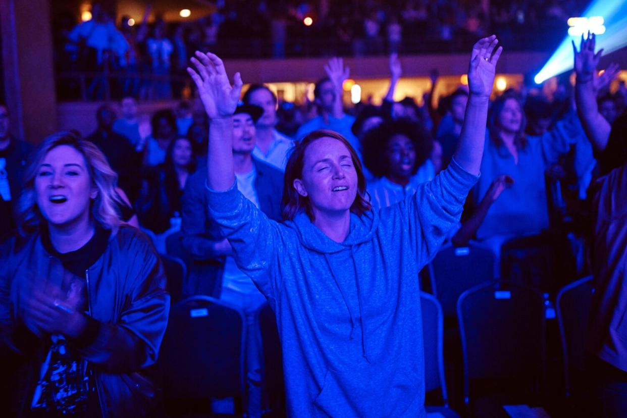 people worship during a service at Hillsong Church in New York