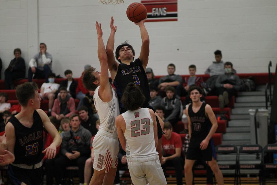 Alec Voegele drives for a lay-up in the second quarter with Zach Moe (2) and Jett Leddy (23) defending inside Brookings High School on Jan. 13, 2022.