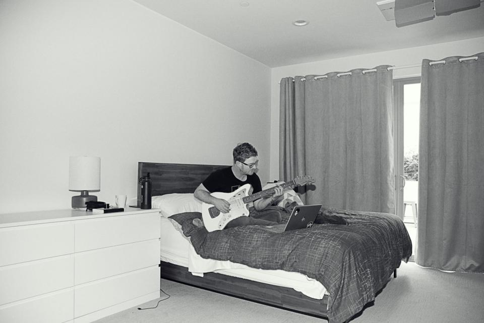 Mike Huguenor finishing up editing the weekly paper from a Portland Airbnb while beginning to warm up for that night’s show, June 3 at Wonder Ballroom. (credit: Hiro Tanaka)