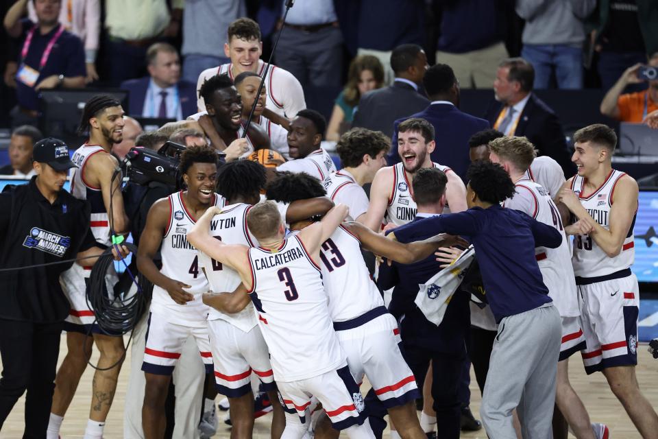 Connecticut players celebrate after defeating the San Diego State in the national championship game of the 2023 NCAA ment's tournament at NRG Stadium.