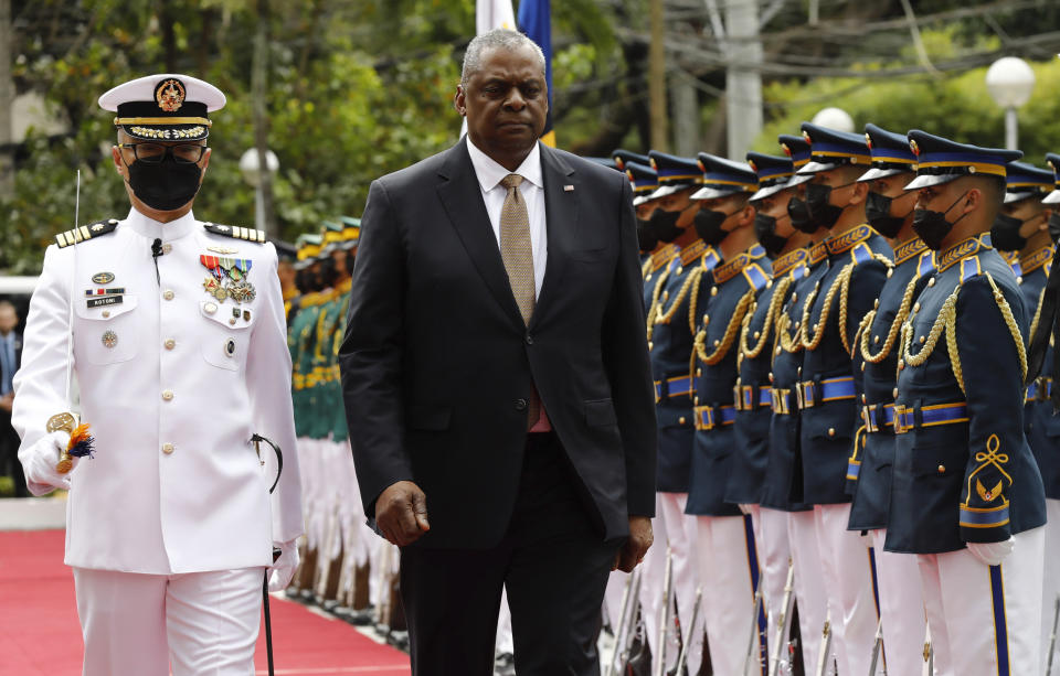 U.S. Defense Secretary Lloyd Austin, second from left, walks past military guards during his arrival at the Department of National Defense in Camp Aguinaldo military camp in Quezon City, Metro Manila, Philippines on Thursday February 2, 2023. (Rolex Dela Pena/Pool Photo via AP)