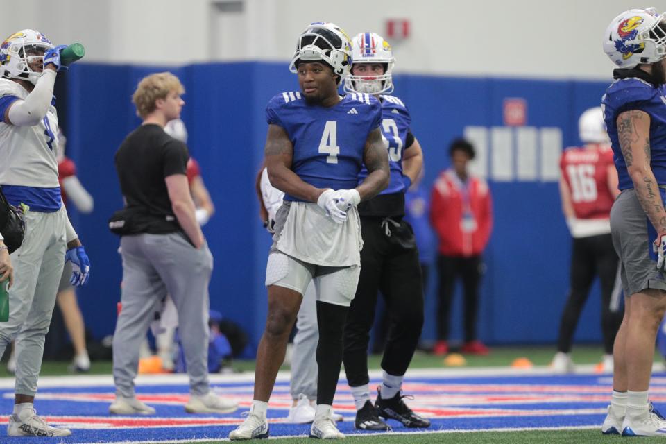 Kansas senior running back Devin Neal (4) looks on during a practice Tuesday inside the team's indoor practice facility.