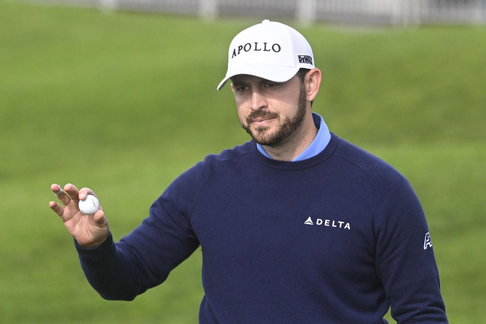 Patrick Cantlay holds up the ball after finishing the first round on the North Course at Torrey Pines, at the Farmers Insurance Open golf tournament Wednesday, Jan. 24, 2024, in San Diego. (AP Photo/Denis Poroy)