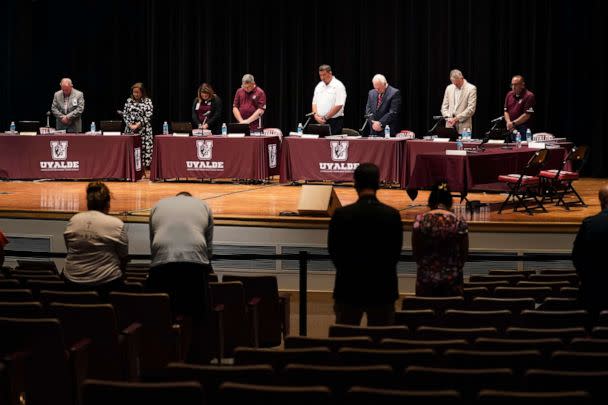 PHOTO: Attendees stand for a moment of silence before a termination hearing to decide the employment fate of Uvalde School District Police Chief Pete Arredondo in Uvalde, Texas, Aug. 24, 2022.  (Eric Gay/AP)