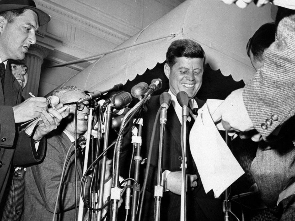 Then-President-elect John F. Kennedy talks to reporters after leaving White House conference.