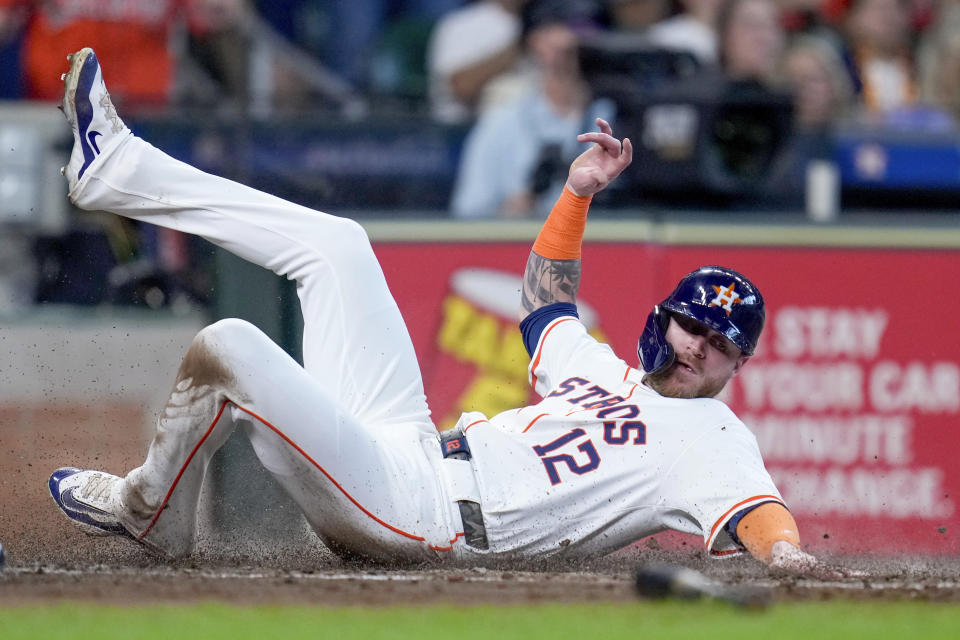 Houston Astros' Ben Gamel slides to score on Yordan Alvarez's RBI single against the Arizona Diamondbacks during the fourth inning of a baseball game Saturday, Sept. 7, 2024, in Houston. (AP Photo/Eric Christian Smith)