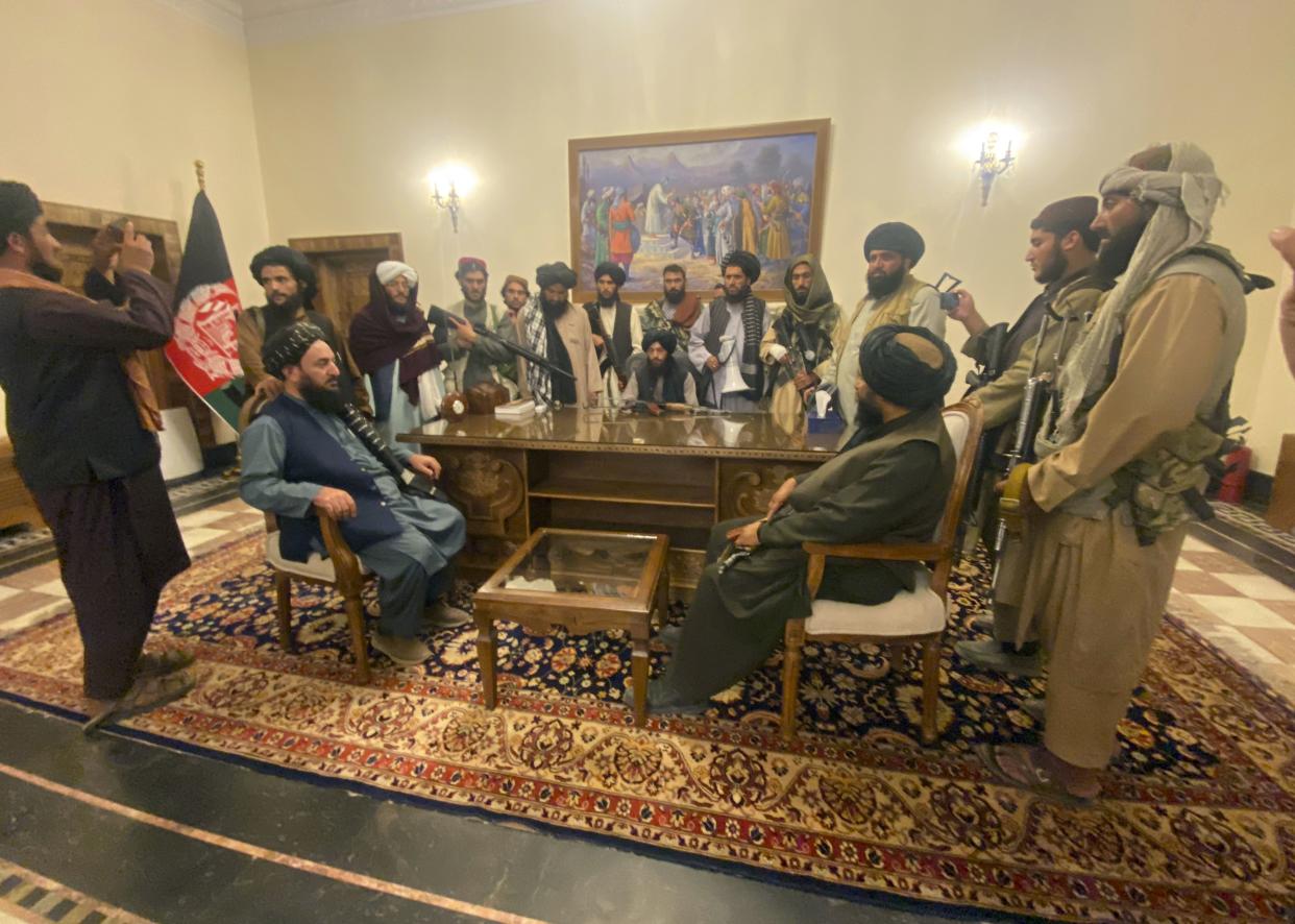 Taliban fighters take control of the Afghan presidential palace after Afghan President Ashraf Ghani fled the country, in Kabul, Afghanistan, Sunday, Aug. 15, 2021.