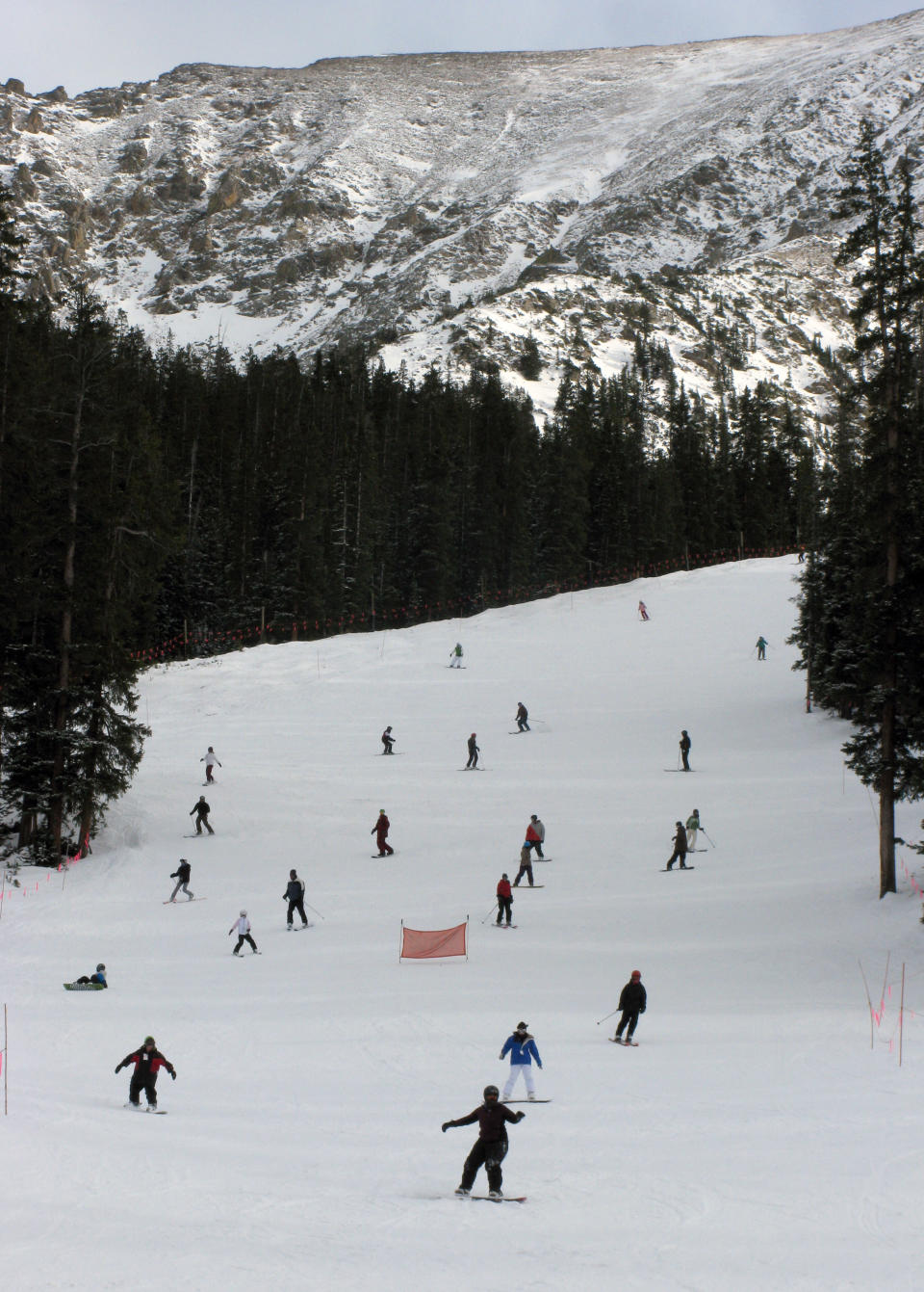 This Nov. 11, 2011 photo provided by Colorado Ski Country USA shows skiers making their way down the slopes at Arapahoe Basin Ski Area near Dillon, Colo. A disappointing snow year in much of Colorado ski country last season has the state's resorts and hotels hoping that snowboarders and skiers will burn off some pent-up demand for deep snow this winter. (AP Photo/Colorado Ski Country USA/John Trousdale)