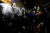 <p>Pro-choice activists stand with their arms up before police, outside Congress where clashes broke out after activists learned lawmakers voted against a bill that would have legalized elective abortion in the first 14 weeks of pregnancy, in Buenos Aires, Argentina, early Thursday, Aug. 9, 2018. (Photo: Natacha Pisarenko/AP) </p>