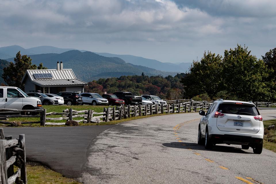 Cars are parked in the Graveyard Fields parking lot as a motorist travels along the Blue Ridge Parkway, October 5, 2023.