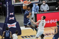 Memphis Grizzlies forward Justise Winslow (7) dunks the ball against Milwaukee Bucks center Brook Lopez (11) in the first half of an NBA basketball game Thursday, March 4, 2021, in Memphis, Tenn. (AP Photo/Brandon Dill)