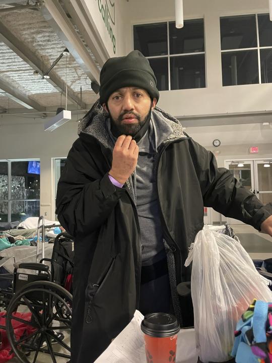 This Jan. 2, 2022 photo provided by OurCalling, LLC shows Malik Faisal Akram, at a Dallas homeless shelter. Akram, the armed man who took four people hostage during a 10-hour standoff at a Texas synagogue on Saturday, Jan. 15, had spent time in area homeless shelters in the two weeks leading up to the attack, and was dropped off at one by someone he appeared to know. (OurCalling, LLC via AP)