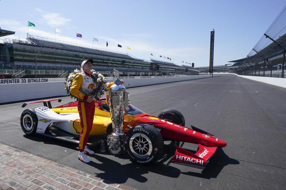 Josef Newgarden poses with the Borg-Warner Trophy during the traditional winners photo session at Indianapolis Motor Speedway, Monday, May 29, 2023, in Indianapolis. Newgarden won the 107th running of the Indianapolis 500 auto race Sunday. (AP Photo/Darron Cummings)