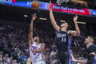 Sacramento Kings forward Keegan Murray (13) blocks the shot of Philadelphia 76ers guard Tyrese Maxey in the first half of an NBA basketball game in Sacramento, Calif., Monday, March 25, 2024. (AP Photo/José Luis Villegas)