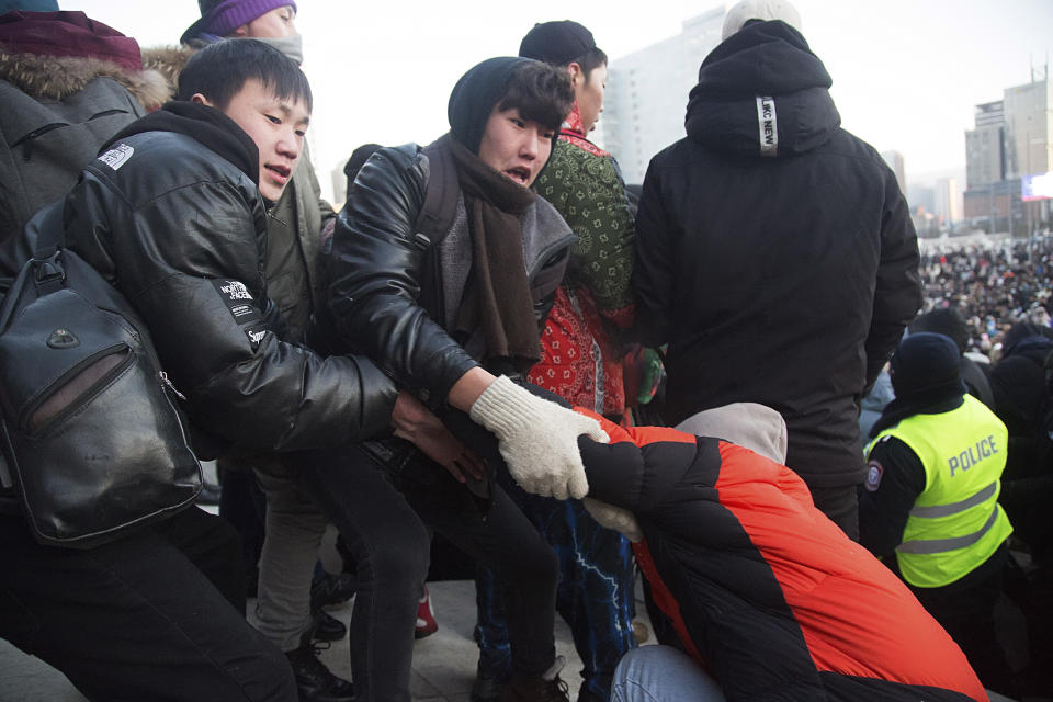 Protesters gather near the State Palace on Sukhbaatar Square in Ulaanbaatar in Mongolia on Monday, Dec. 5, 2022. Protesters angered by allegations of corruption linked to Mongolia's coal trade with China have stormed the State Palace in the capital, demanding dismissals of officials involved in the scandal. (AP Photo/Alexander Nikolskiy)