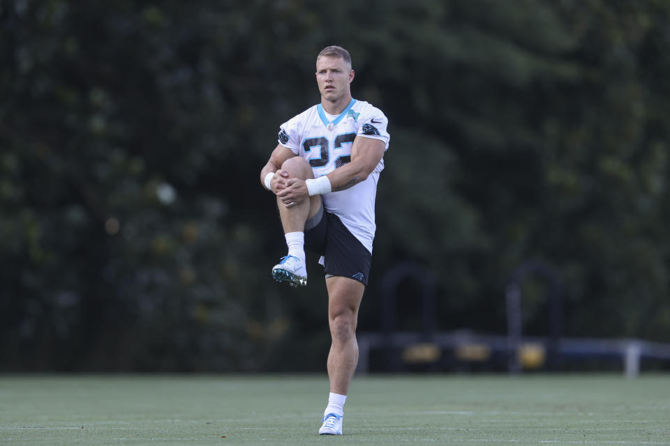 Carolina Panthers running back Christian McCaffrey stretches at the NFL football team's training camp in Spartanburg, S.C., Wednesday, July 28, 2021. (AP Photo/Nell Redmond)