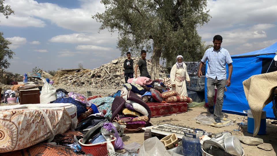 Abdu Brahim and his wife Hanan Ait Brahim sort through the items they recovered from the rubble of their home, where their 7-year-old daughter died. - Ivana Kottasová/CNN