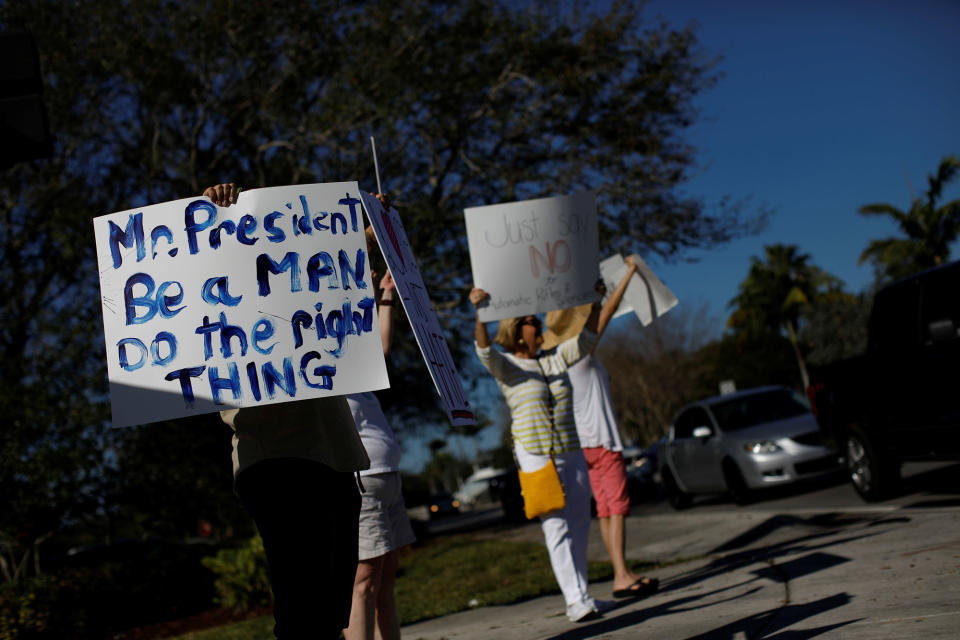 <p>People holding placards take part in a protest in support of the gun control at a street corner in Coral Springs, Fla., Feb. 17, 2018. (Photo: Carlos Garcia Rawlins/Reuters) </p>