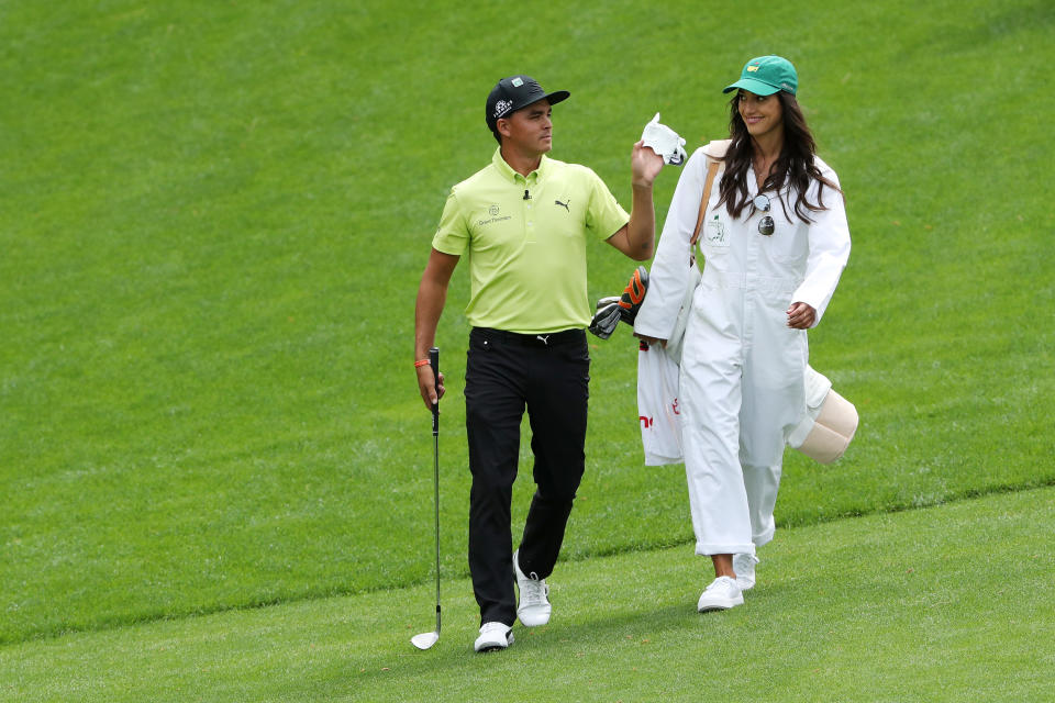 Rickie Fowler and Allison Stokke walk down the fairway at the Masters