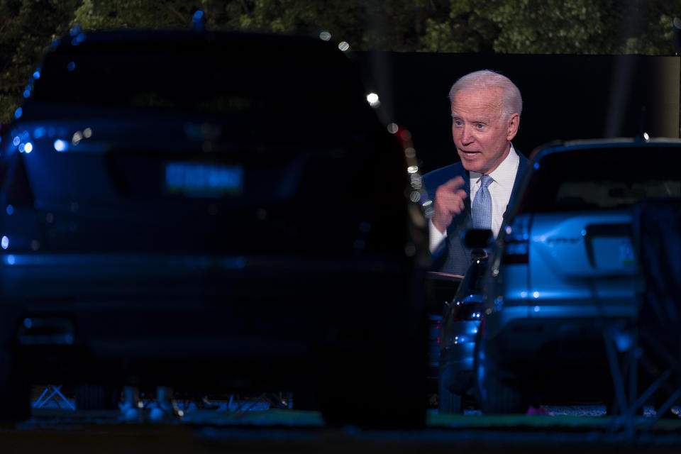 Audience members watch from their cars as Democratic presidential candidate former Vice President Joe Biden, seen on a monitor, speaks during a CNN town hall in Moosic, Pa., Thursday, Sept. 17, 2020. (AP Photo/Carolyn Kaster)