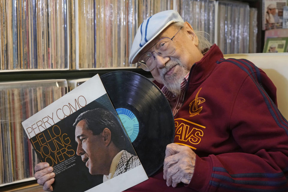 FILE - Ray Cordeiro, Hong Kong's oldest DJ displays records at his home in Hong Kong, Thursday, May 27, 2021. Cordeiro considers himself the luckiest radio DJ in the world. Cordeiro, who interviewed music acts including the Beatles during a six-decade career on Hong Kong radio that earned him the title of the world's longest-working disc jockey, died Friday, Jan. 13, 2023, his former employer announced. He was 98. (AP Photo/Kin Cheung, File)