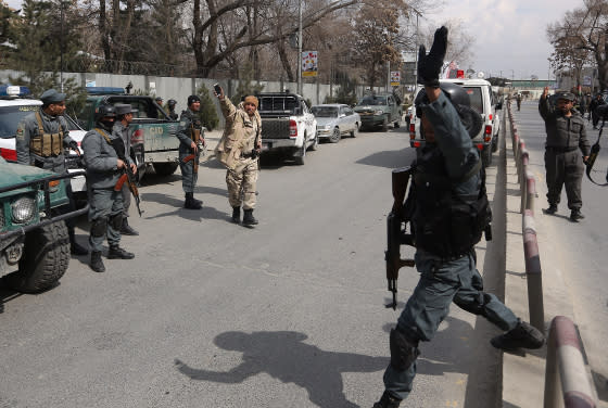 Security forces inspect the site of attack on a military hospital in Kabul, Mar. 8, 2017.