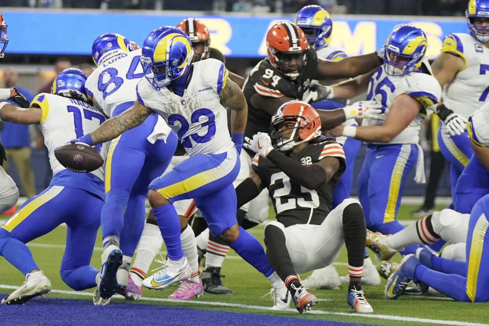 Los Angeles Rams running back Kyren Williams, left, scores a rushing touchdown past Cleveland Browns cornerback Martin Emerson Jr. (23) during the second half of an NFL football game Sunday, Dec. 3, 2023, in Inglewood, Calif. (AP Photo/Mark J. Terrill)