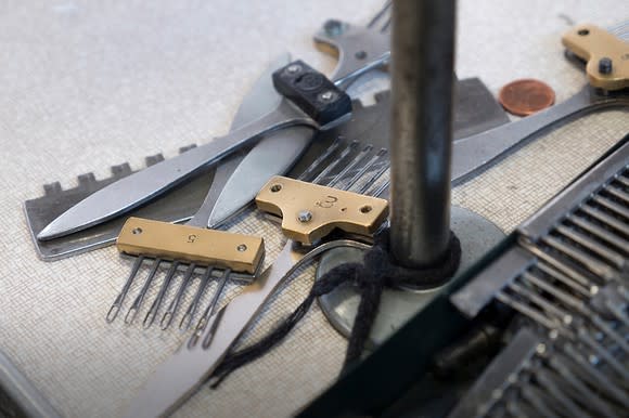 Shears and various fabric tools on a flat surface at a Canada Goose production facility.