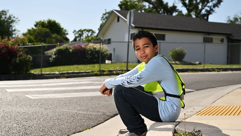 Hector Lara poses for photos near South Kearns Elementary School on Monday, June 17, 2024, where he is a patroller. Hector was awarded the AAA School Safety Patrol Lifesaving Medal. Recipients are select patrollers who, while on duty, have saved the life of a person in imminent danger.