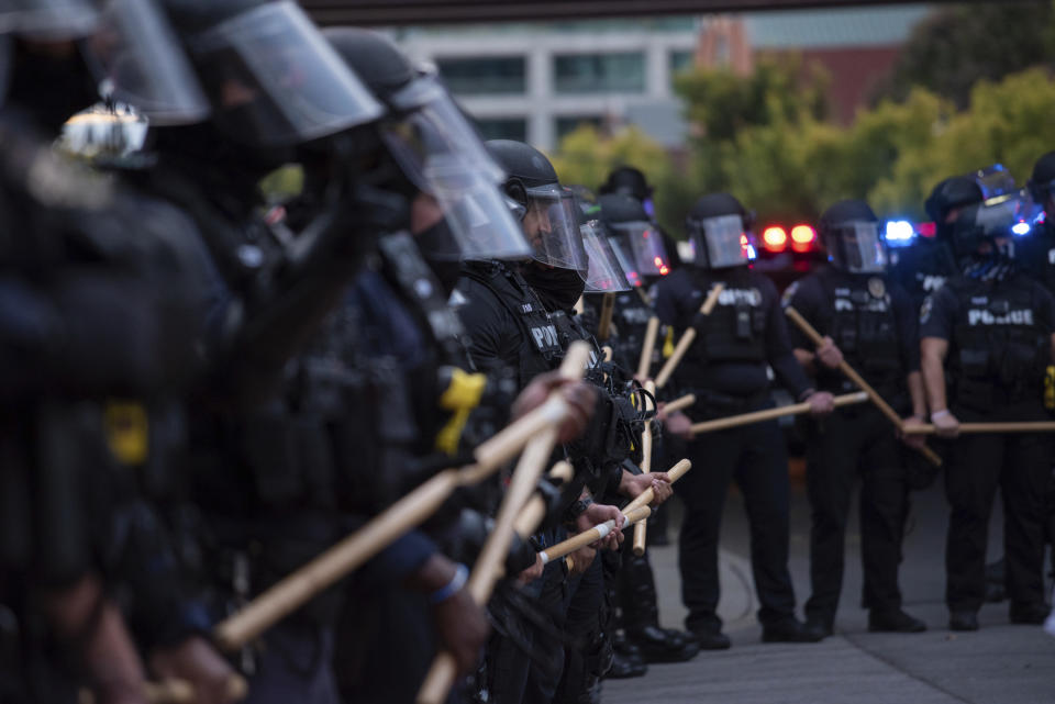 In this Sept. 25, 2020 photo, a line of police officers block protesters in Louisville, Ky. Most police officers who violate citizens’ rights get away with it because the law is heavily stacked in their favor, legal experts say. (Isabel Miller via AP)