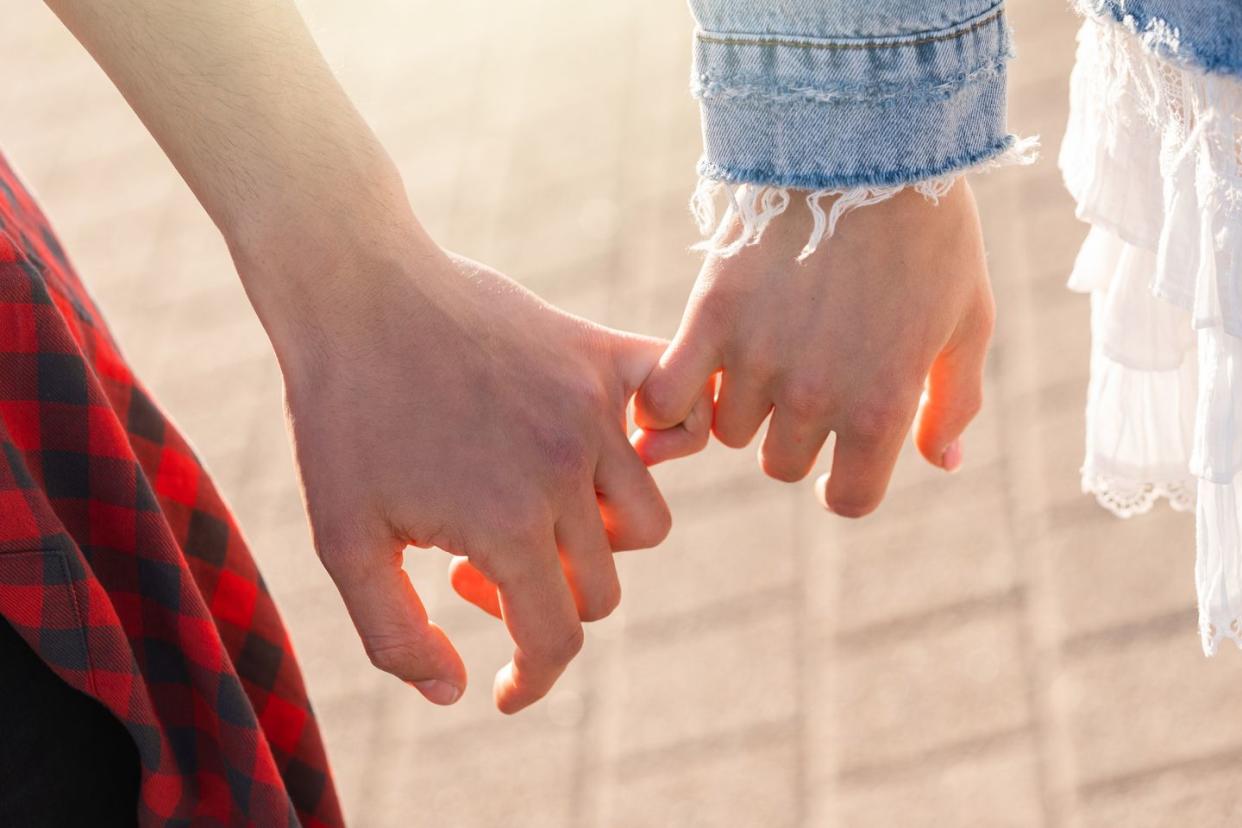 couple holding hands with a pinky grip