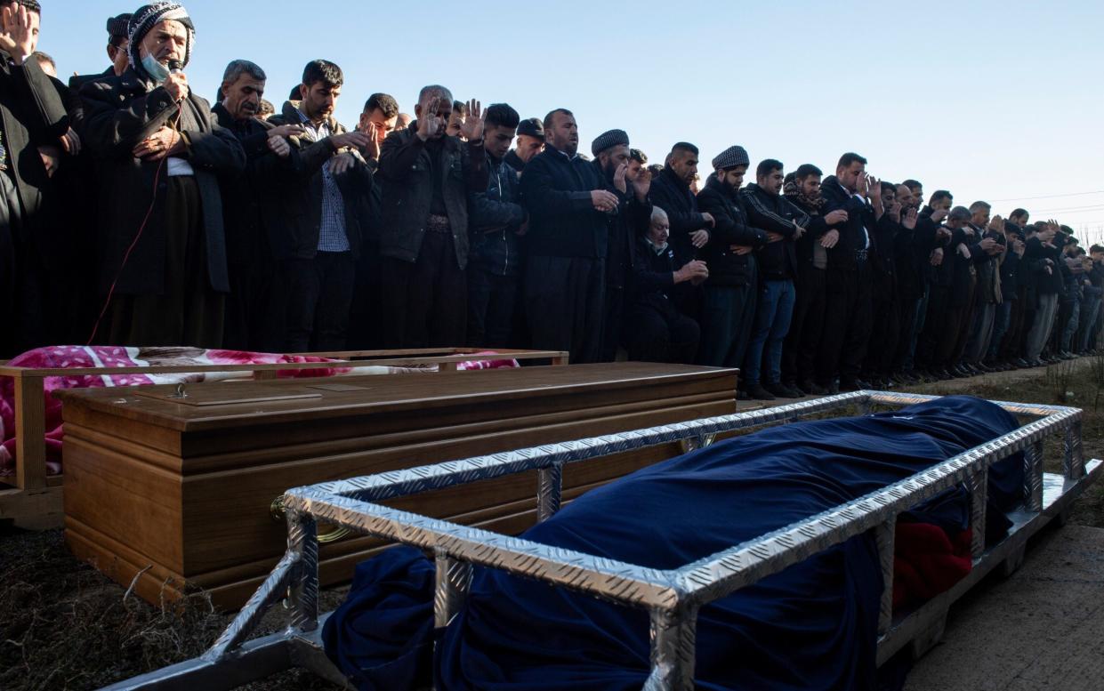 Men outside a mosque in the town of Ranya pray over the bodies of three migrants before burial - Hawre Khalid/Getty Images Europe