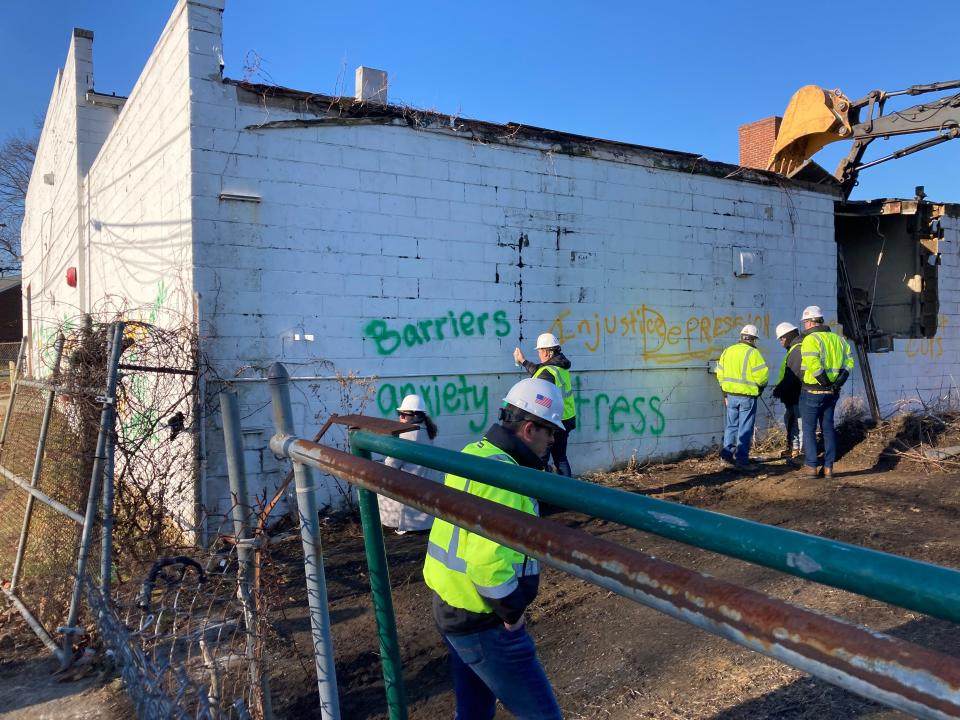 Demolition of a commercial building to make way for a STEM education center at EastSide Charter School is about to commence as staff and community members leave messages on the building.