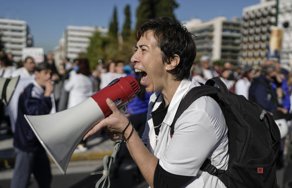 FILE - Healthcare workers opposing mandatory coronavirus vaccinations and the suspension from work for those who refuse to get the shots, chant slogans during a protest outside the Greek Parliament , in central Athens, on Wednesday, Nov 3, 2021. (AP Photo/Petros Giannakouris, File)