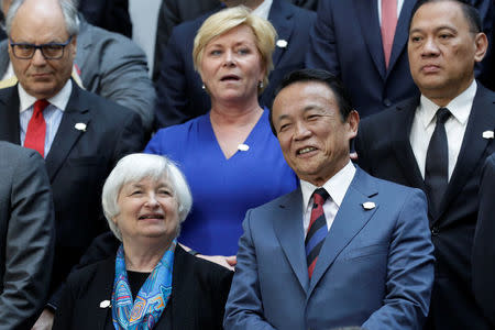 Federal Reserve Chair Janet Yellen (L) and Japanese Finance Minister Taro Aso pose for G-20 family photo during the IMF/World Bank spring meetings in Washington, U.S., April 21, 2017. REUTERS/Yuri Gripas