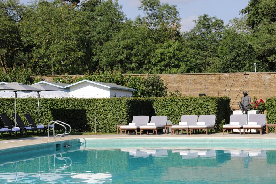 <p>Sitting amid 300 acres of verdant Hertfordshire countryside, this five-star hotel with an outdoor pool is close to London while feeling a world away. </p><p>The swimming pool is set within <a href="https://www.booking.com/hotel/gb/the-grove-hertfordshire.en-gb.html?aid=2200763&label=hotels-outdoor-pools" rel="nofollow noopener" target="_blank" data-ylk="slk:The Grove;elm:context_link;itc:0;sec:content-canvas" class="link ">The Grove</a>'s walled garden, alongside a man-made beach strewn with deckchairs – who needs to head to a crowded seaside spot when you've got it all here?</p><p>A serene spot for an outdoor swim, the heated pool is where you can stretch out and soak up the rays on one of the padded sun loungers. There's also the Gazebo serving up drinks in the summer and the Potting Shed overlooking the pool, where you can sink into a comfy armchair with a board game.</p><p><a class="link " href="https://www.booking.com/hotel/gb/the-grove-hertfordshire.en-gb.html?aid=2200763&label=hotels-outdoor-pools" rel="nofollow noopener" target="_blank" data-ylk="slk:BOOK NOW;elm:context_link;itc:0;sec:content-canvas">BOOK NOW</a></p>