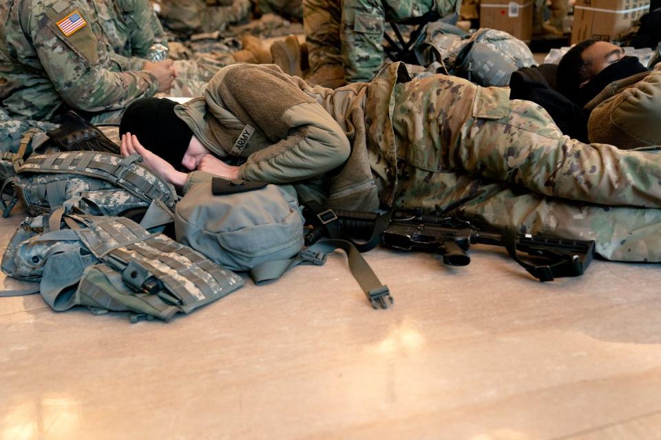 <p>A member of the National Guard sleeps in the Visitor Center of the U.S. Capitol on January 13, 2021 in Washington, DC.</p>