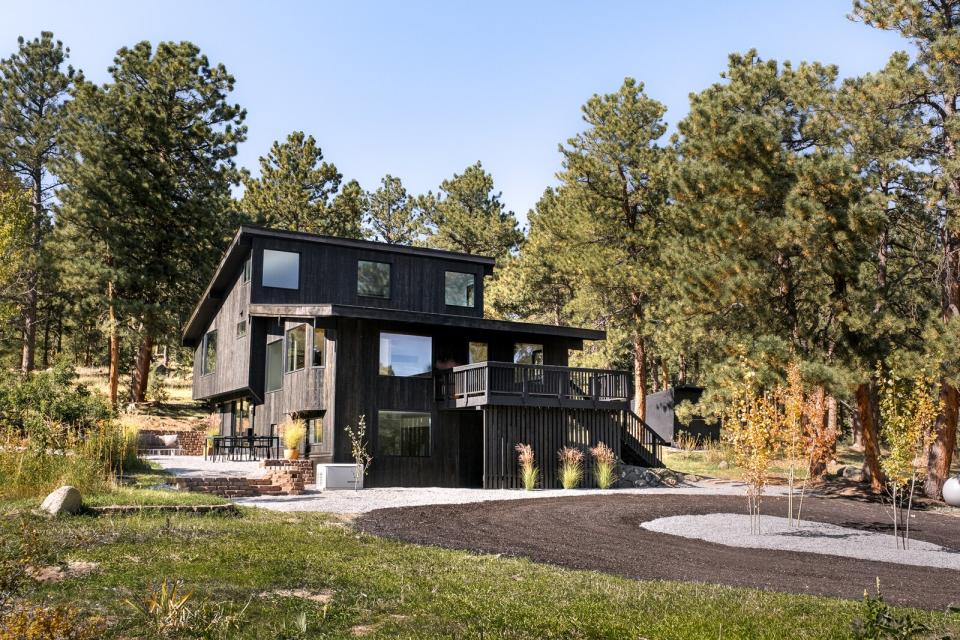 This revamped 1970s residence has an open plan peppered with picture windows to frame the surrounding woods.