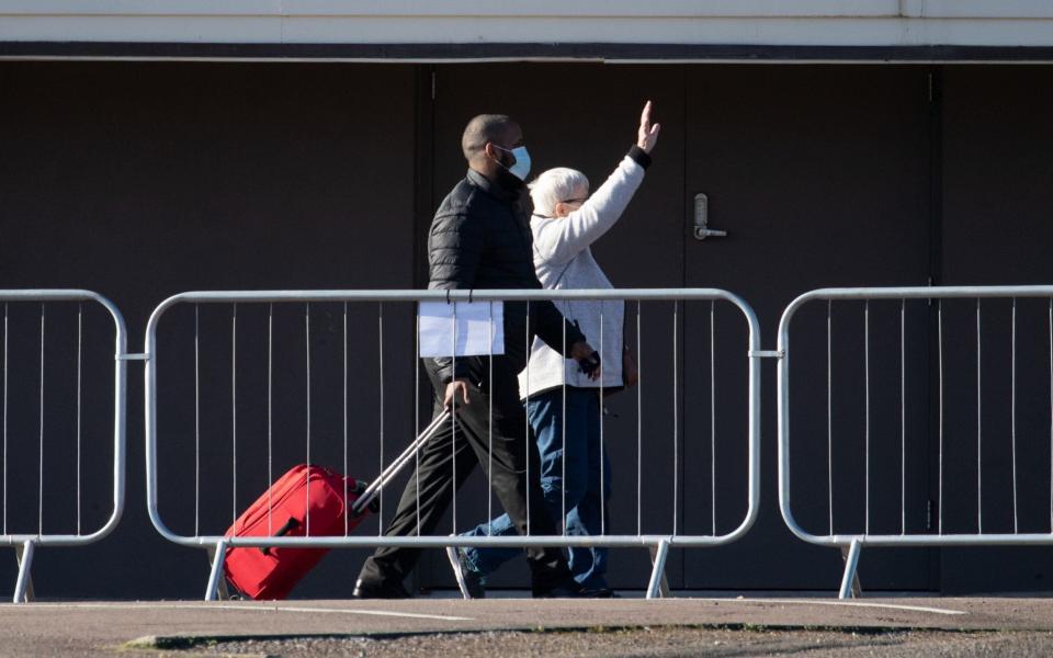 A person waves as they leave the Radisson Blu Edwardian hotel - Andrew Matthews/PA