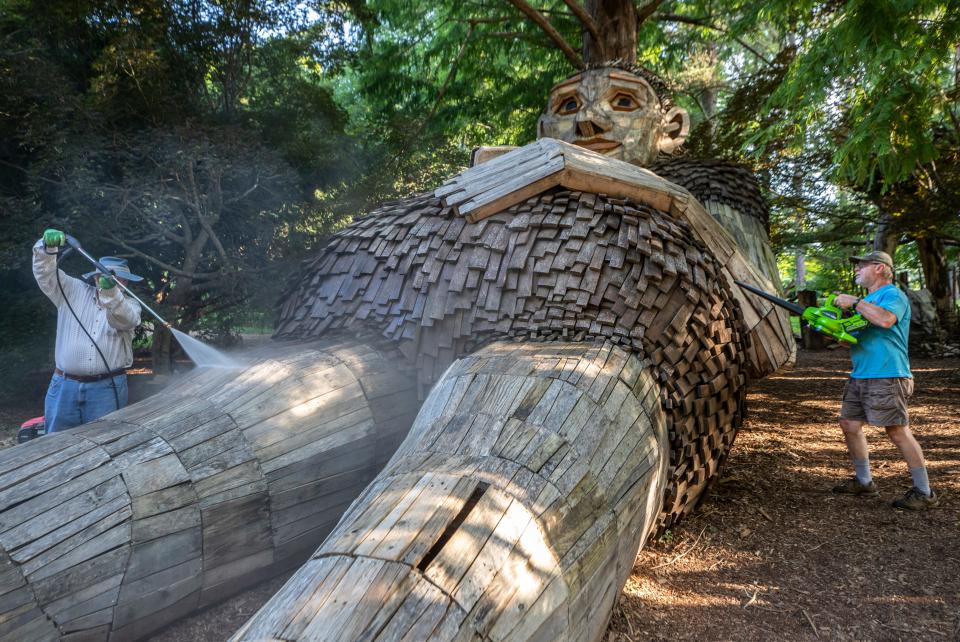 Lee Hutchins, left, power washed the legs of  giant troll Mama Loumari at Bernheim Forest, while Doug Wilson blew debris away as part of an annual cleaning. July 20, 2022