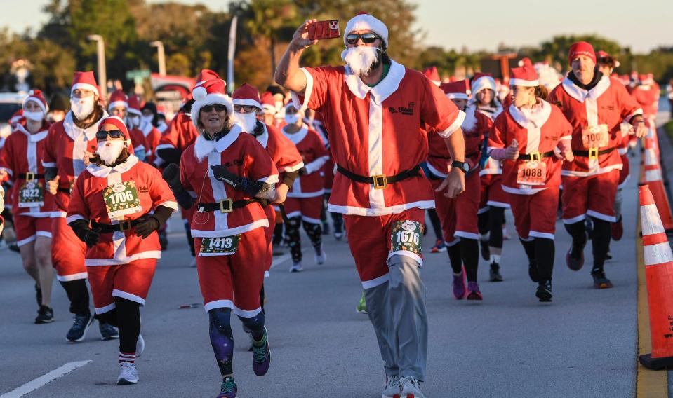 More than 800 runners dressed as Santa Claus braved near freezing temperatures to participate in the Run Run Santa 1 Mile Saturday Dec. 24, 2022 in Viera, Fla (AP)