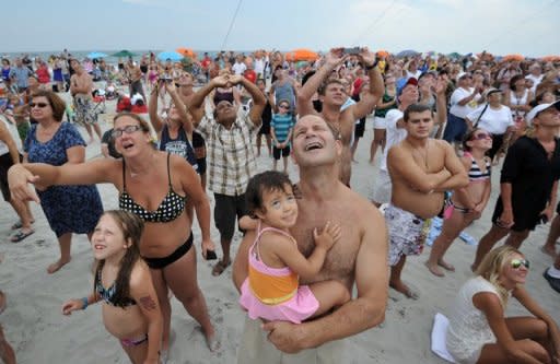 People watch daredevil Nik Wallenda tightrope walk at the Atlantic City, New Jersey, beach